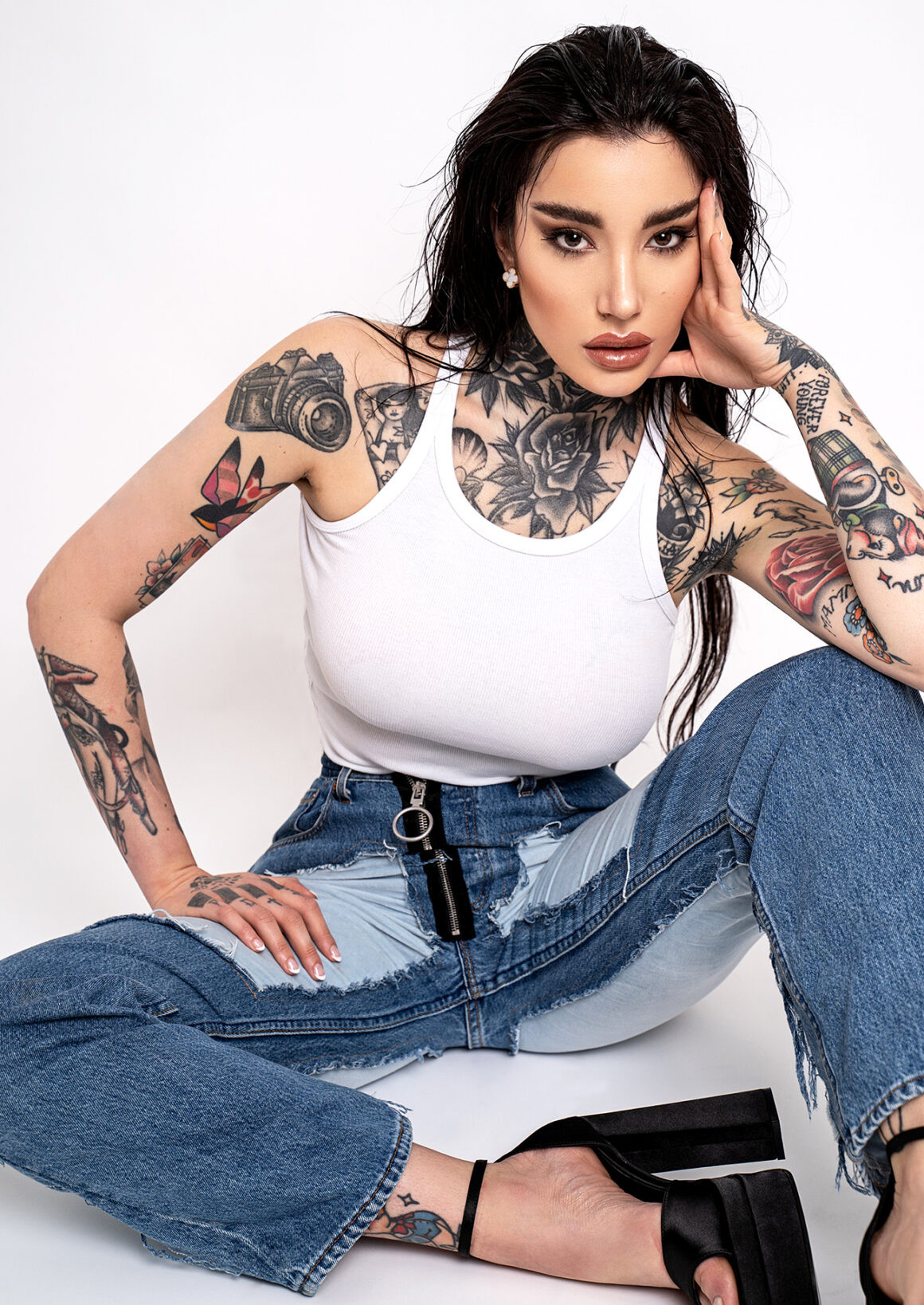 Fashion and tattoo model Lucrezia showcasing arm tattoos in an urban setting