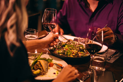 Two people eating healthy food at a restaurant.