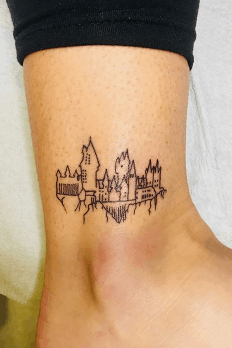 Simple line art Hogwarts castle tattoo, a delicate and understated design for Harry Potter enthusiasts