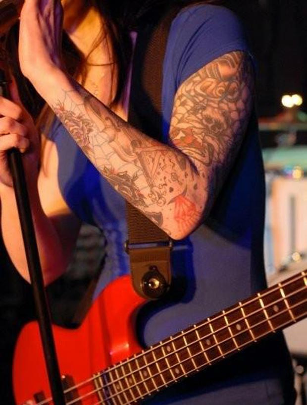 Close-up of Sarah Orloff's microphone tattoo on her shoulder, a cute and symbolic tattoo representing her love for singing.