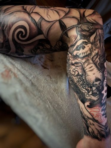 Initial grey shading applied to the Kitsune tattoo, adding depth and dimension to the linework