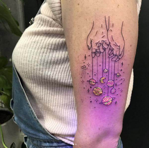 A black light tattoo featuring vibrant colors and intricate details, demonstrating the artistic possibilities with UV ink.