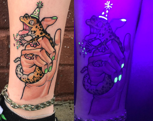 Detailed view of a Xenomorph mouth tattoo using UV ink to mimic plastic vampire teeth, showcasing the green glow under blacklight.