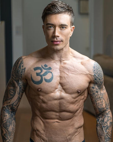 Headhunterz chest tattoo featuring the Om symbol, representing spiritual essence and universal sound.