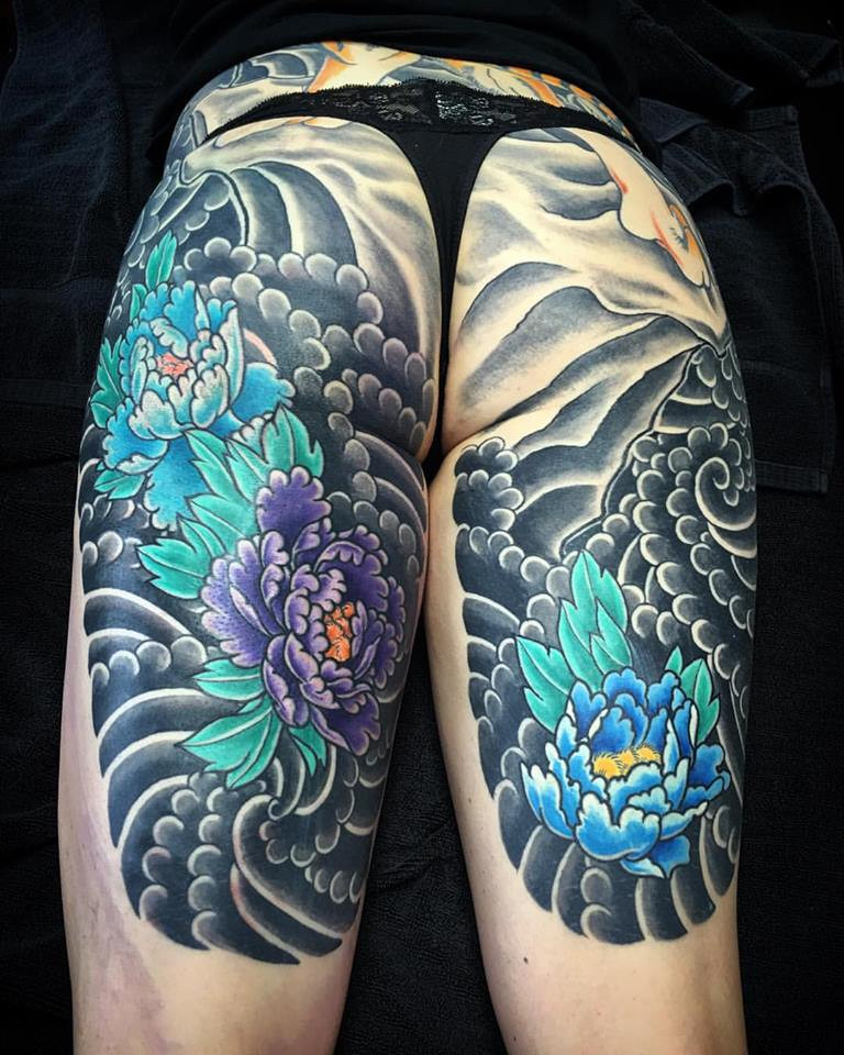 Peonies on thighs as part of a Tiger back piece tattoo by Kian Horisumi Forreal, showcasing peonies used to enhance a powerful tiger backpiece, symbolizing strength and prosperity.