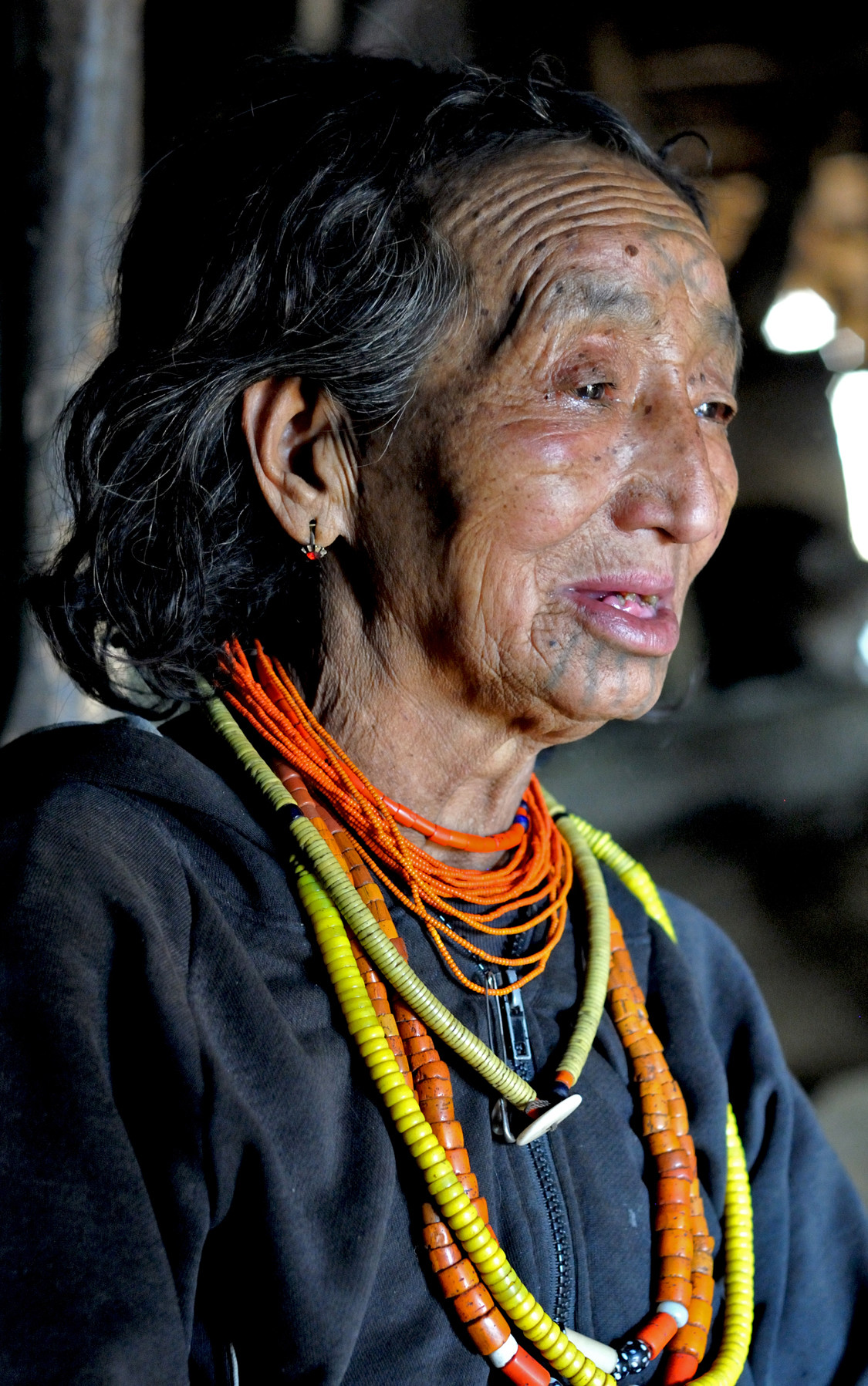 Ma Taw Pa, the last Macham tattoo artist encountered, showcasing the fading tradition of Naga hand-tapped tattoos. She represents a disappearing art form and cultural heritage.