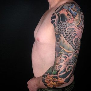 3/4 sleeve tattoo featuring koi fish and peony flowers by Ning Chula