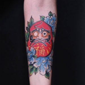 Daruma and Peony Forearm Tattoo by Jess Martucci