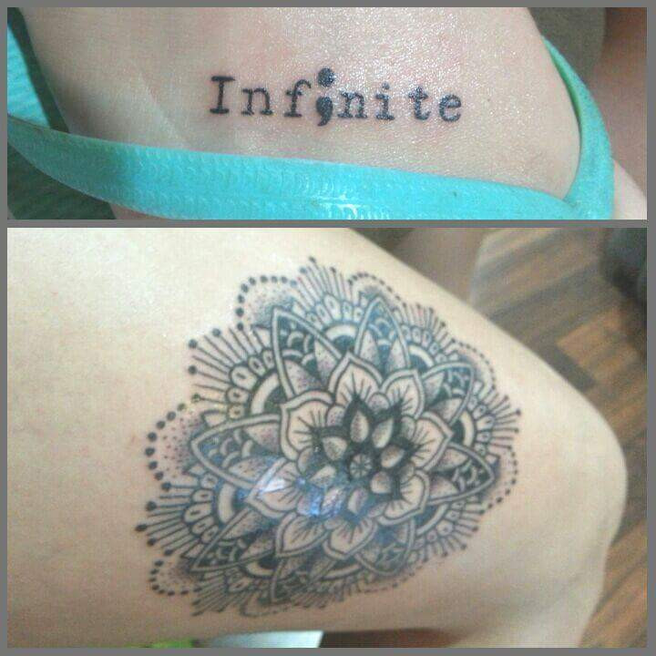 Two tattoos on a person. One on the ribcage area reading &quot;infinite&quot; and another on the leg showing a mandala design.