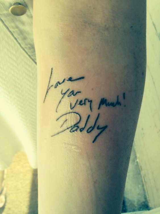 Tattoo of handwritten message "I love you very much! -Daddy" on a woman's arm.