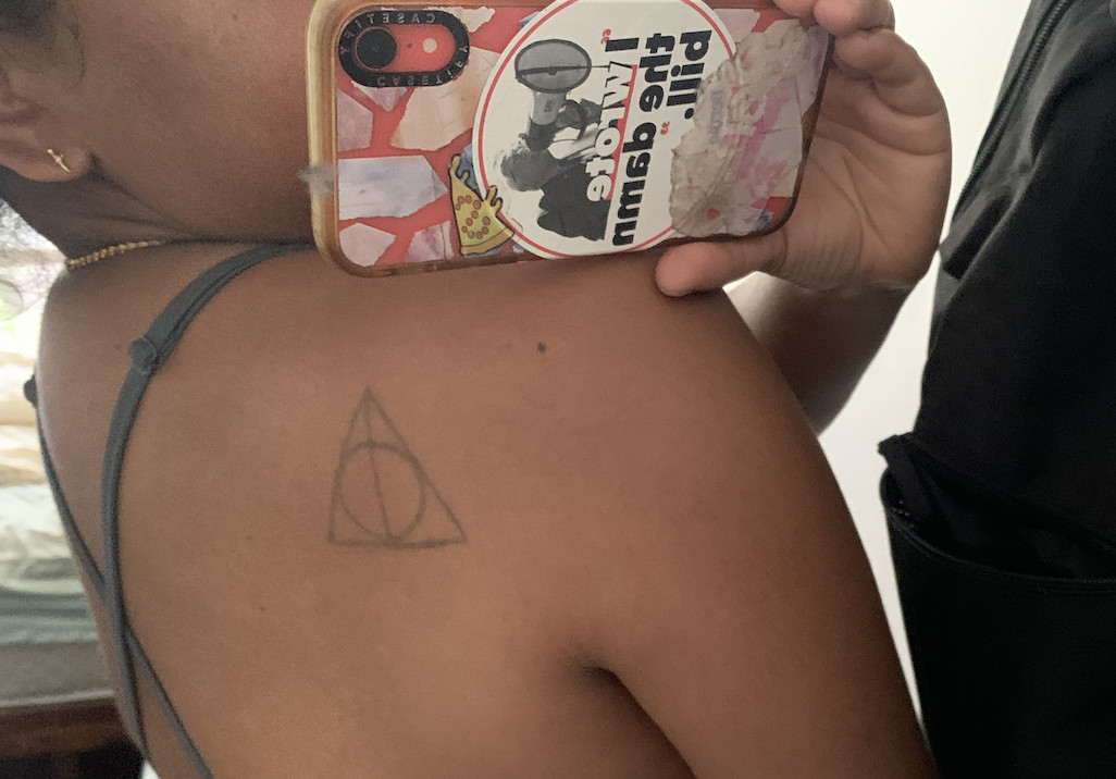 A deathly hallows tattoo on someone