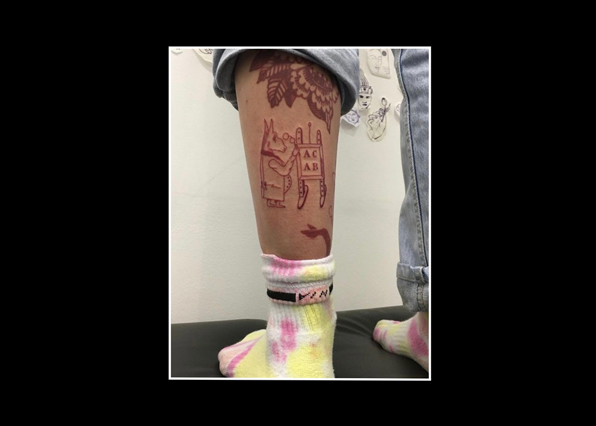 ACAB tattoos – red ink drawing of a donkey dressed in 19th century aristocratic clothes and carrying spectacles, looking at an elementary school blackboard with mathematical equations - anti police tattoo for tattoo artist