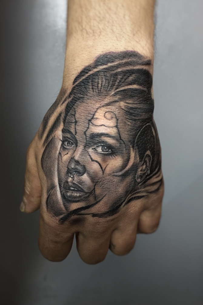 Chicano Girl Tattoo. Black and grey Chicano girl tattoo showcasing fine line detail and classic Chicano aesthetics, highlighting the enduring appeal of Chicano girl tattoo designs.