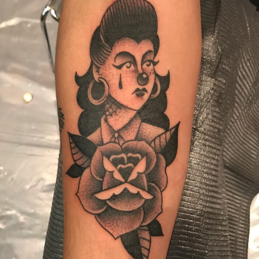 Tattoo by Panchos Placas. Payasa lady head Chicano tattoo by Panchos Placas with sad girl and spiderweb elements in black and grey, showcasing the iconic payasa and spiderweb imagery common in Panchos Placas's Chicano tattoos.