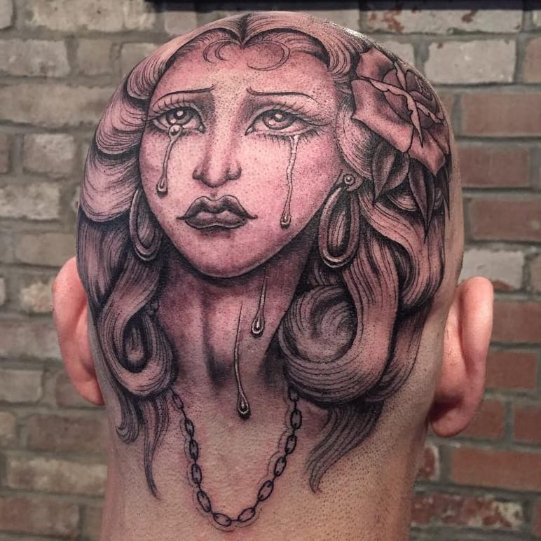 Tattoo by Tamara Santibanez. Sad girl Chicano tattoo by Tamara Santibanez featuring a lady head with tears and roses in black and grey, exemplifying the emotional depth and fine line detail in Tamara Santibanez's Chicano tattoos.