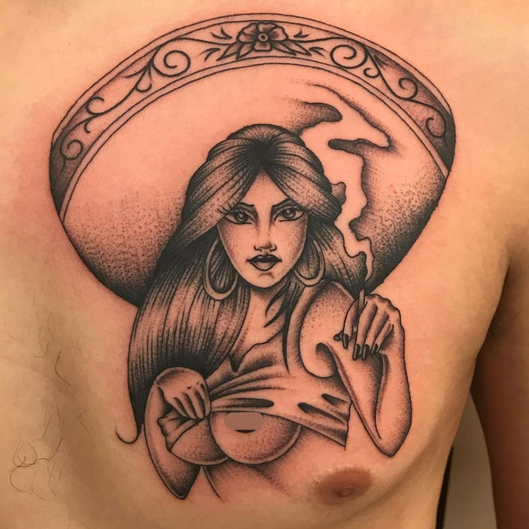 Tattoo by Javier DeLuna Design by Chuco Moreno. Collaborative Chicano tattoo by Javier DeLuna and Chuco Moreno featuring a lady with a sombrero portrait in black and grey, exemplifying the artistry and collaboration within Chicano tattoo culture.