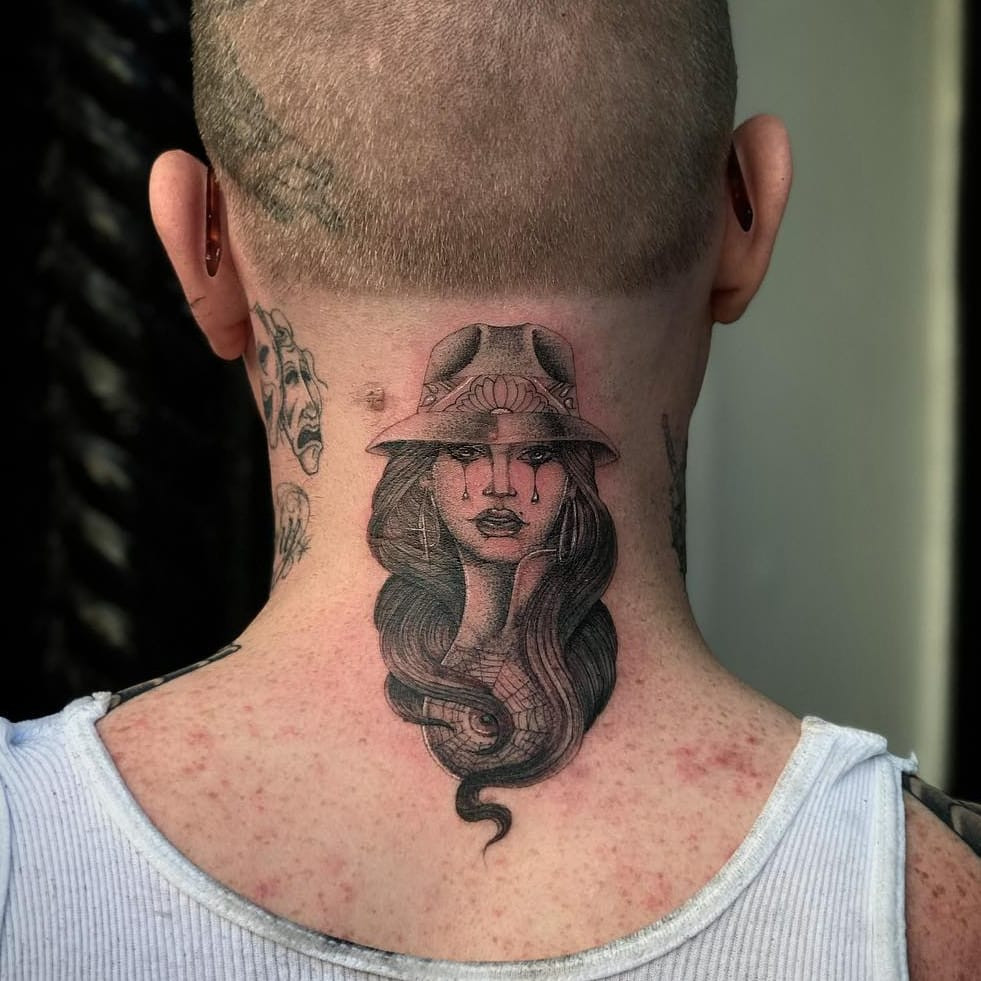 Tattoo by Big Steve. Classic Chicano tattoo design by Big Steve featuring a sad girl payasa with spiderweb details, rendered in black and grey, showcasing the iconic imagery of Chicano tattoo culture.