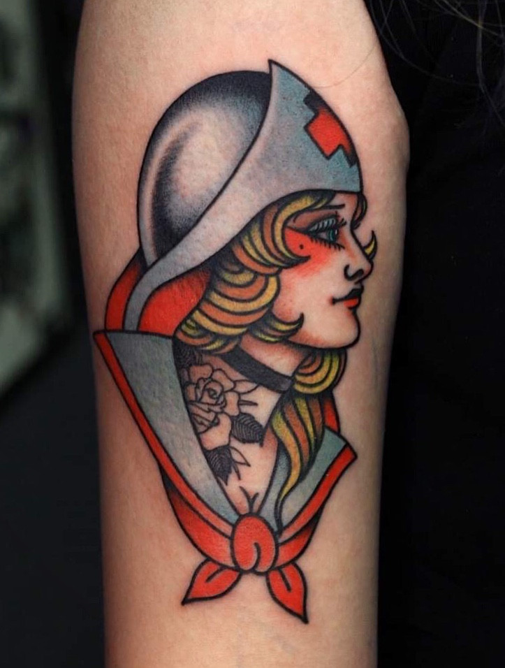 Vibrant and colorful pin-up girl tattoo with floral elements.
