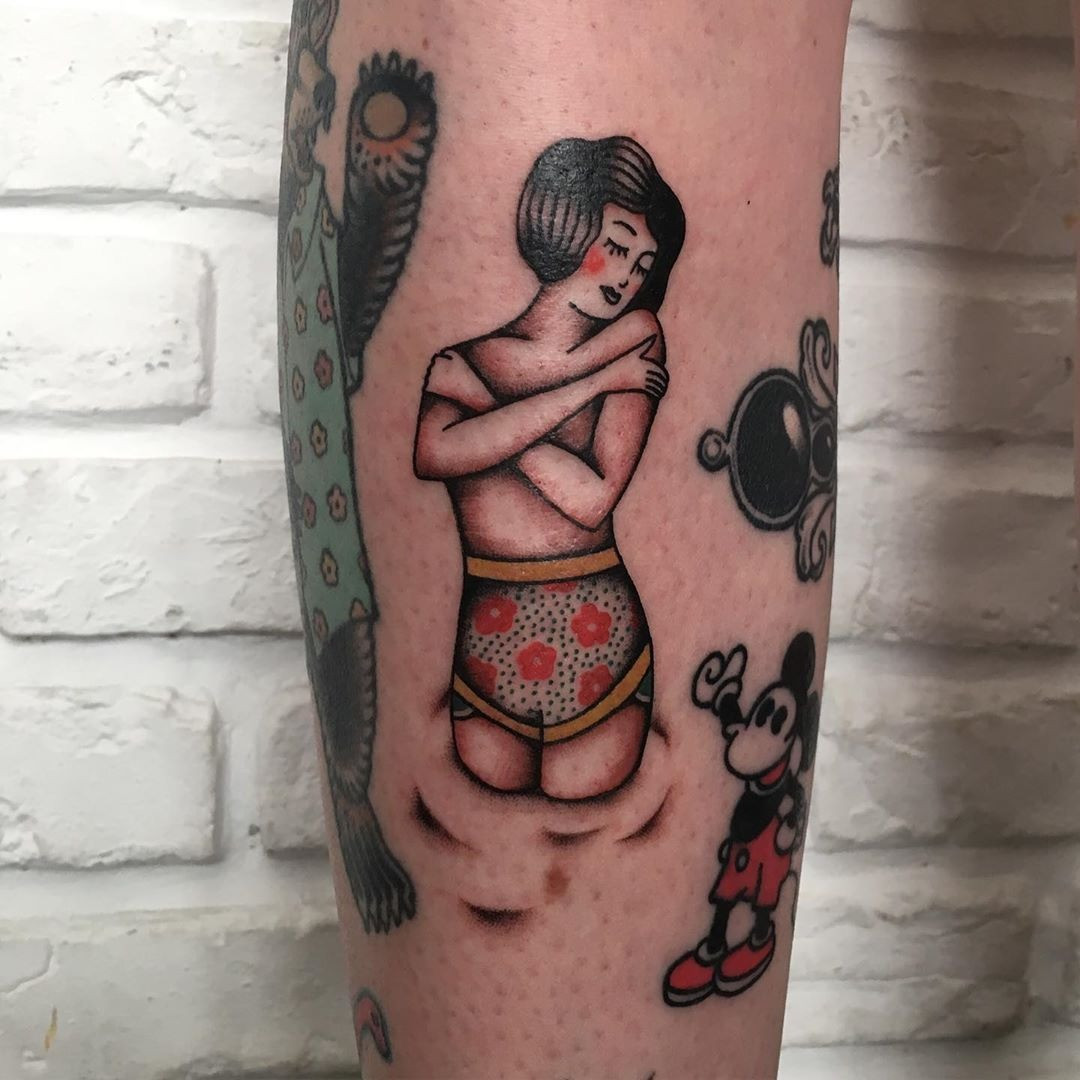 Illustrative pin-up girl tattoo in a unique style.