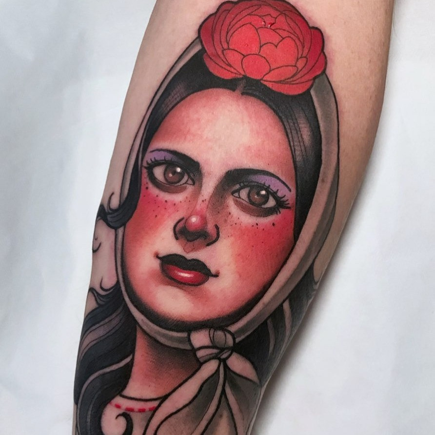 Traditional female pin-up tattoo inspired by early tattoo flash art, reflecting the historical roots of pin-up tattooing.