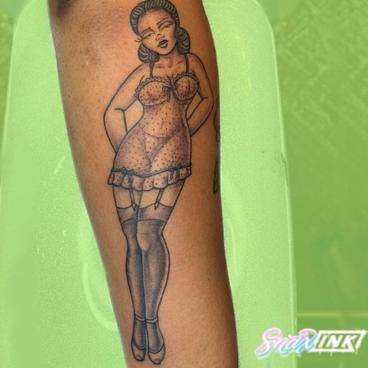 Elegant female pin-up tattoo in a vintage fashion advertisement style, reminiscent of Christian Dior's campaigns.