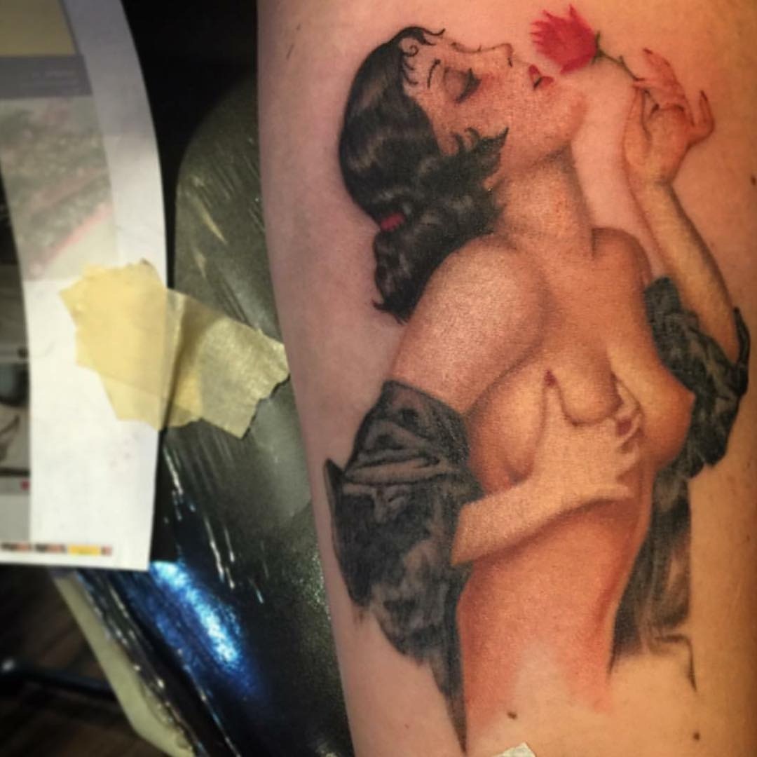 Vintage female pin-up tattoo showcasing the provocative yet tasteful style of early pin-up imagery.