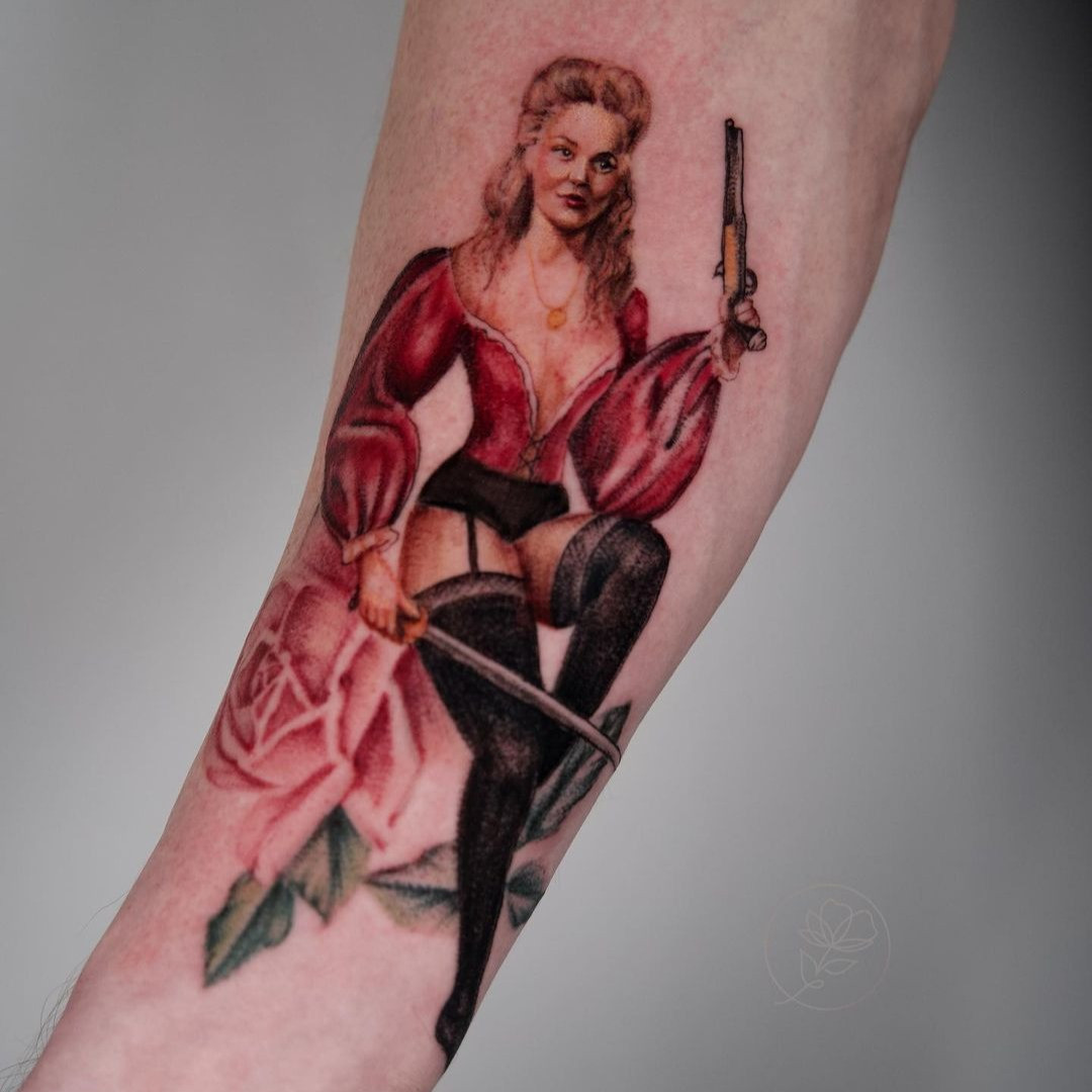 Artistic female pin-up tattoo inspired by pin-up illustrators like Vargas, showcasing painterly qualities.