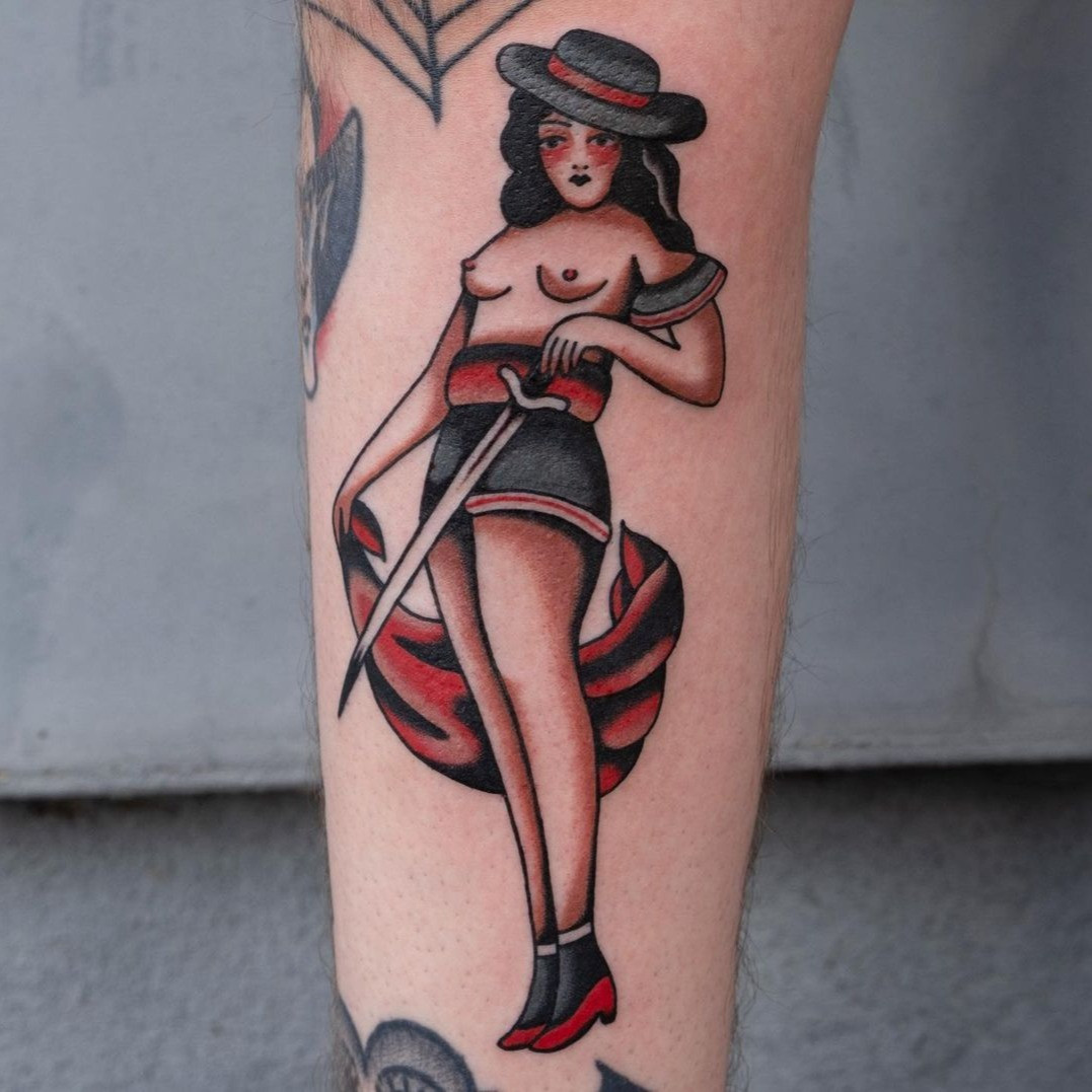 Feminist female pin-up tattoo inspired by Rosie the Riveter, symbolizing female empowerment and strength.