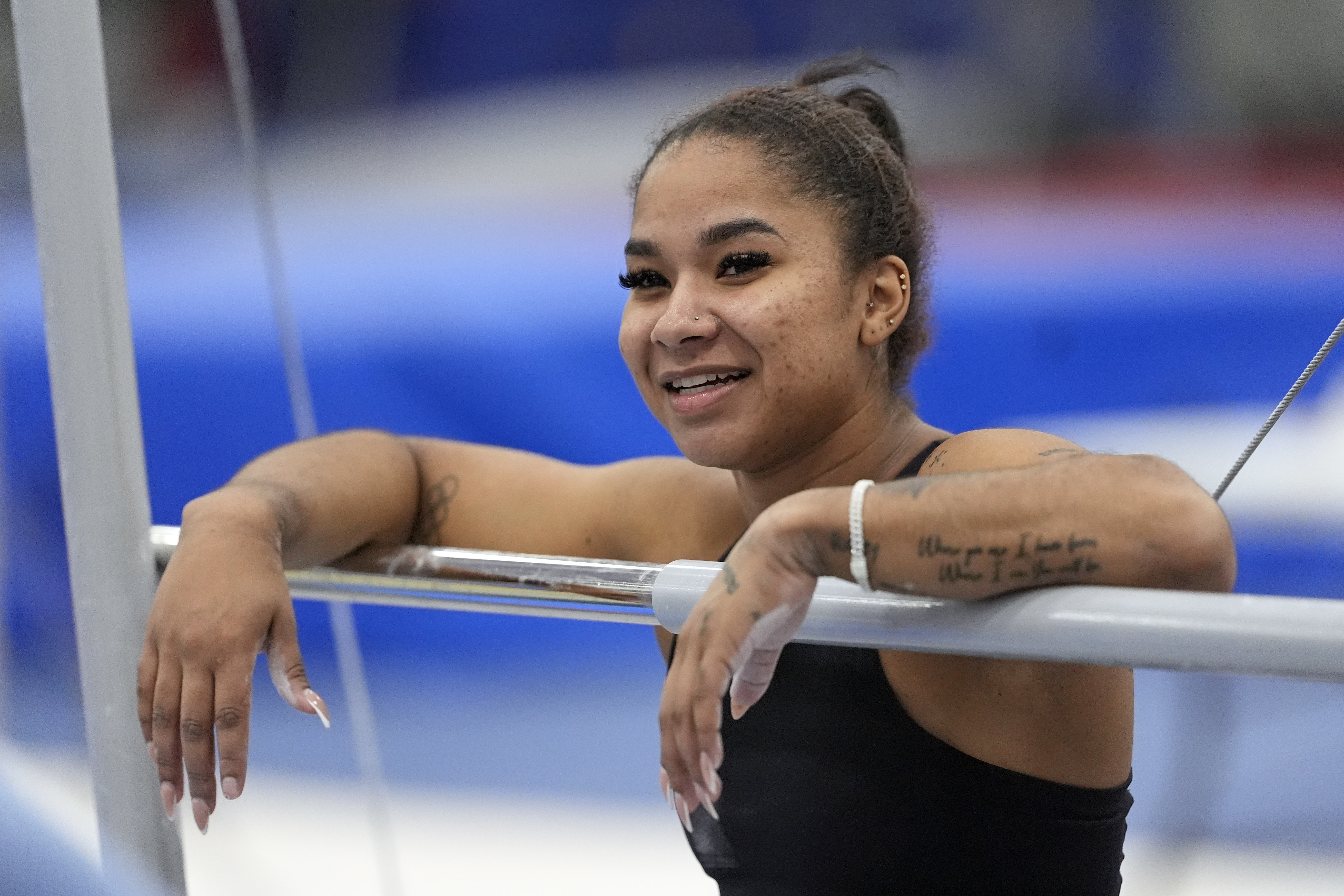 Jordan Chiles' grandfather tribute tattoo, featuring a meaningful quote, is visible during a training session.