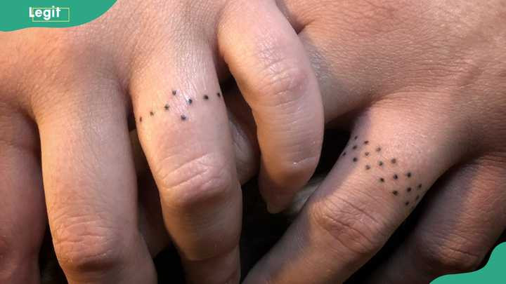 Dots around the finger tattoo offering a minimalist and unique alternative to traditional rings.