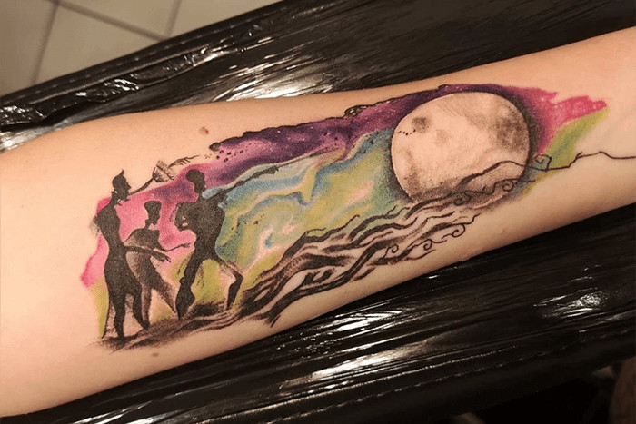 Colorful &quot;Tale of the Three Brothers&quot; tattoo, a vibrant and illustrative depiction of the Harry Potter story