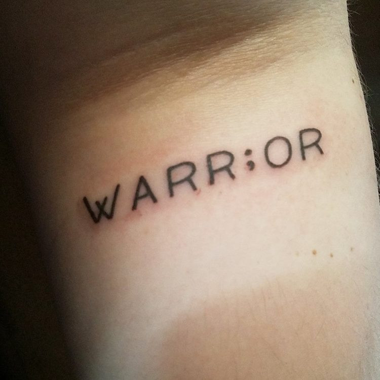 Tattoo with the word warrior in script font