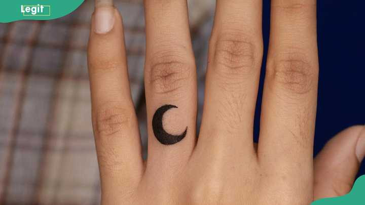 Moon ring tattoo symbolizing the cyclical nature of life and enduring guidance.