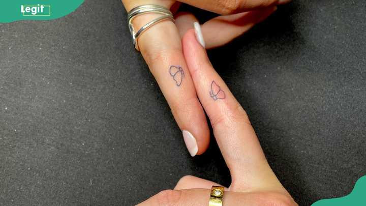 Butterfly wedding ring tattoos representing transformation and freedom in love.
