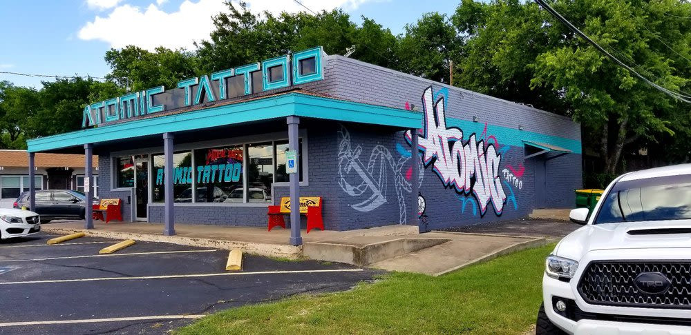 Atomic Tattoo shop front in Austin, recognizable branding for a well-known tattoo chain.