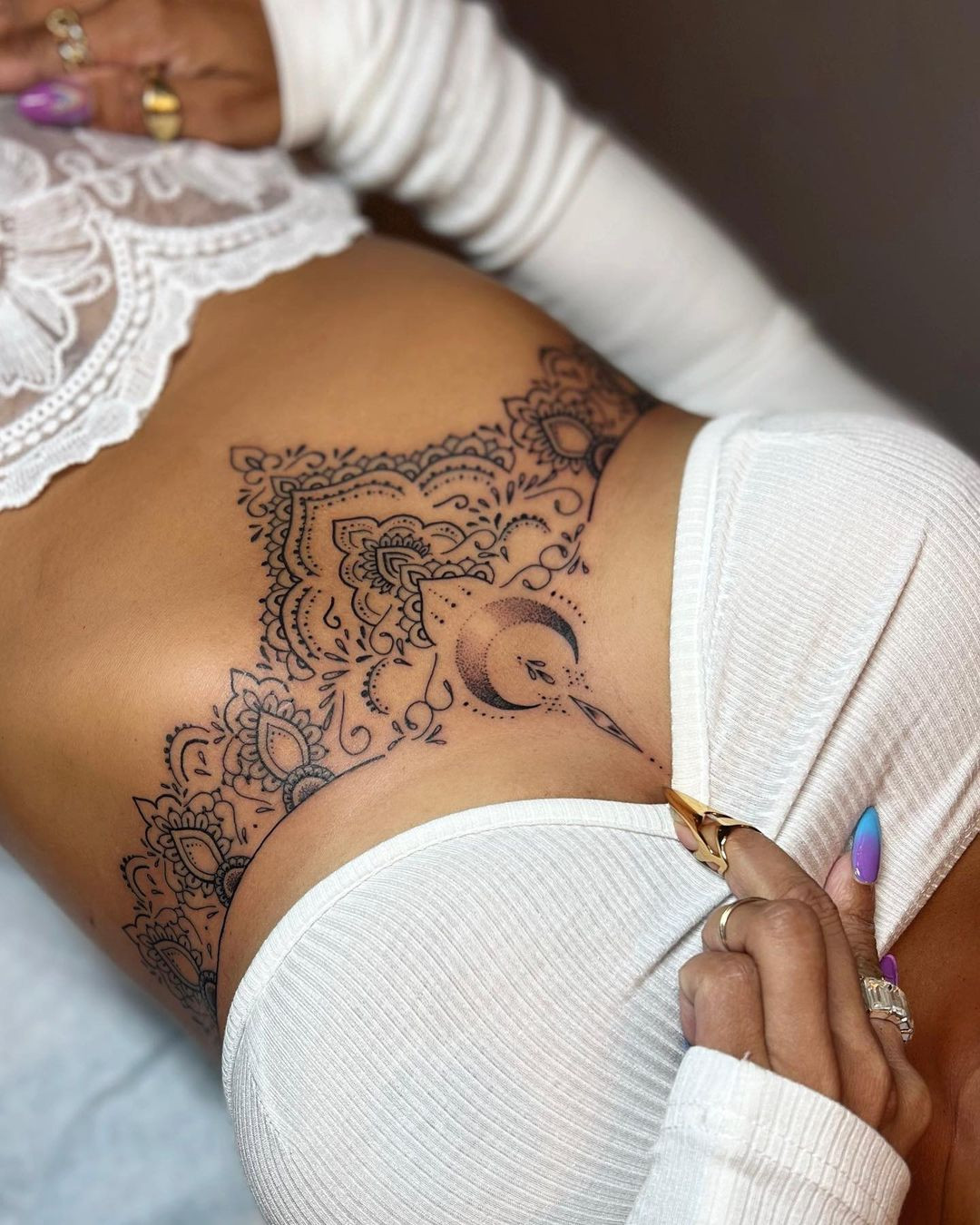 Underbust sternum tattoo, intricate and Rihanna-inspired design