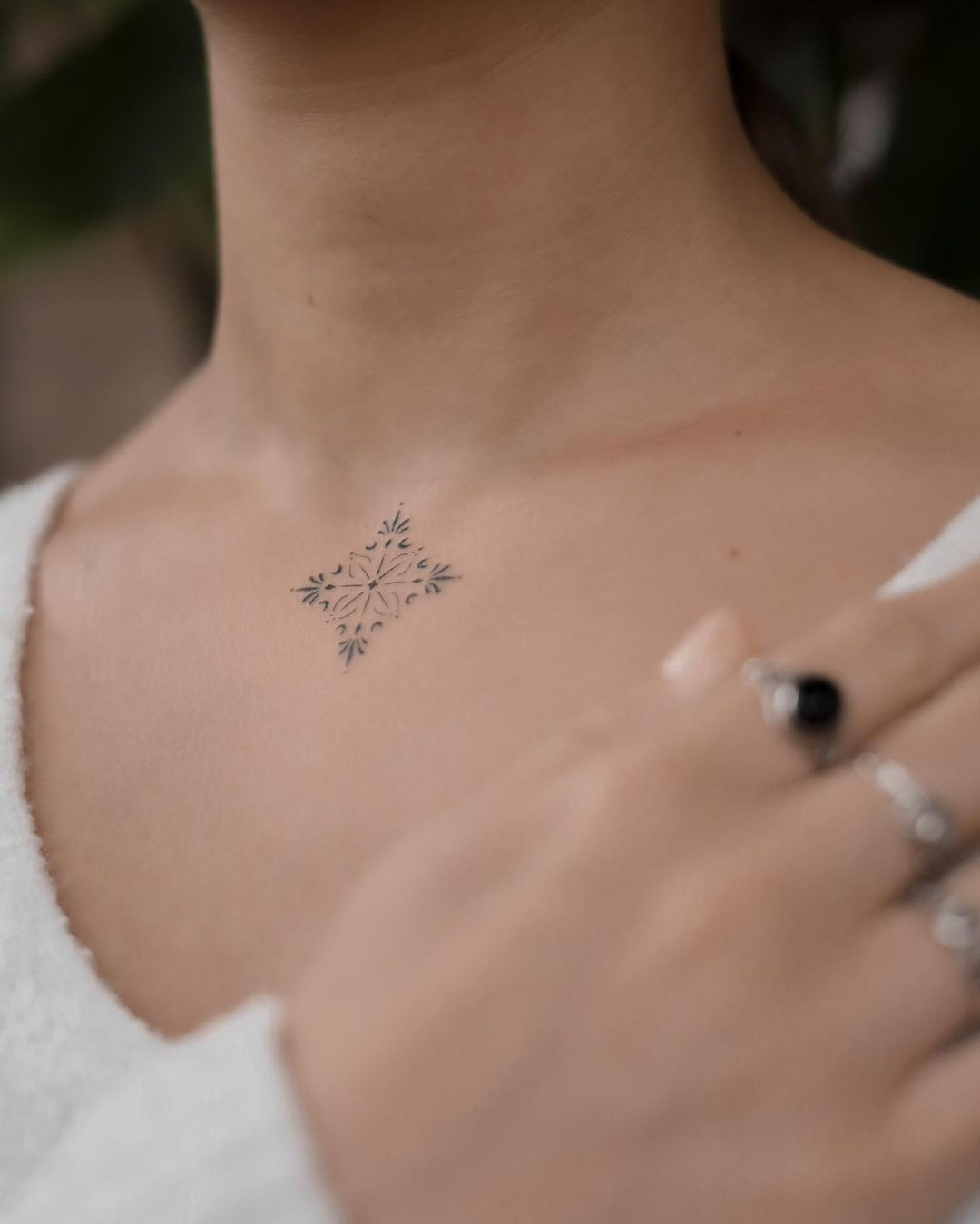 Mandala effect tattoo on upper arm, minimalist dotwork design