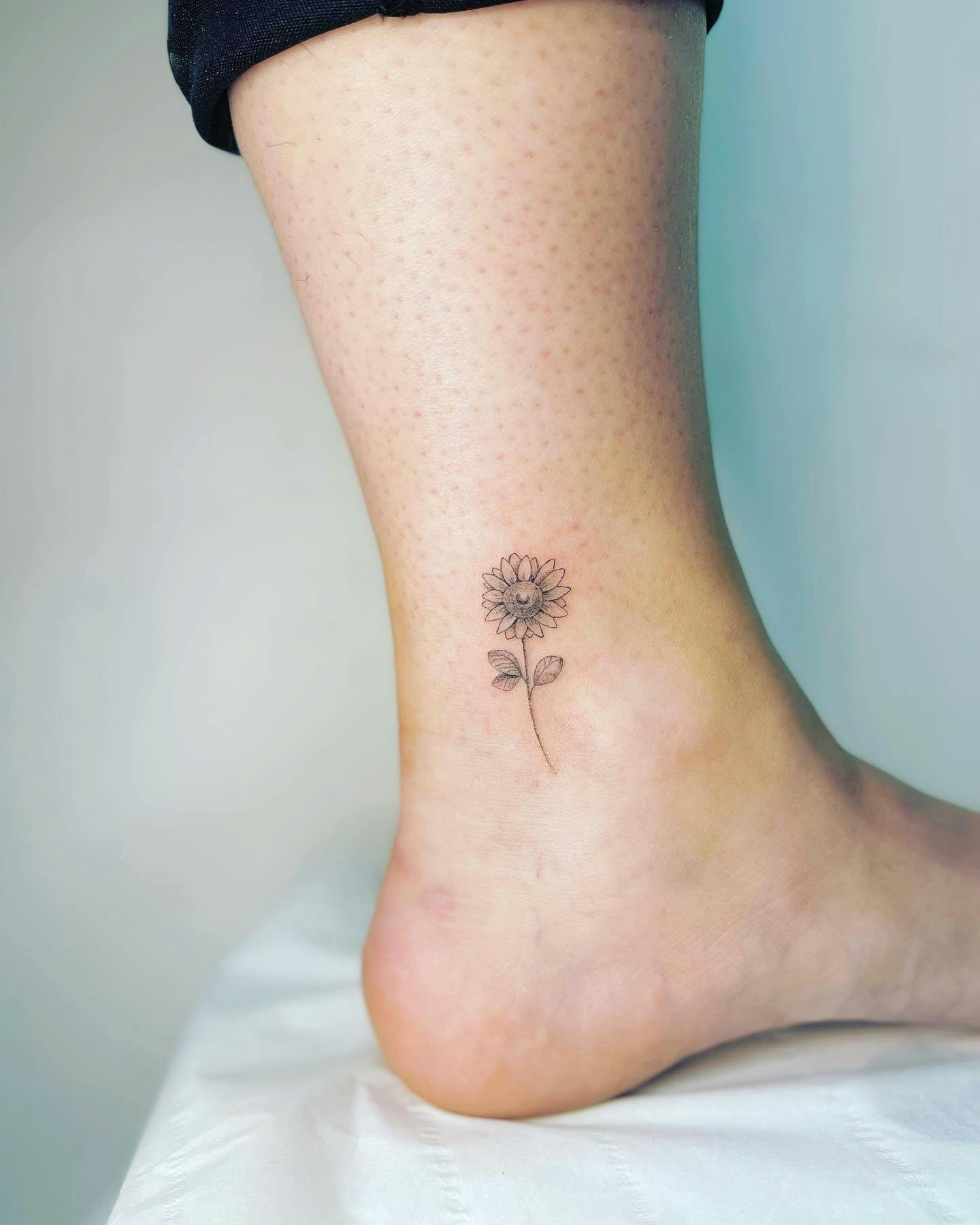 Sunflower ankle tattoo for positivity