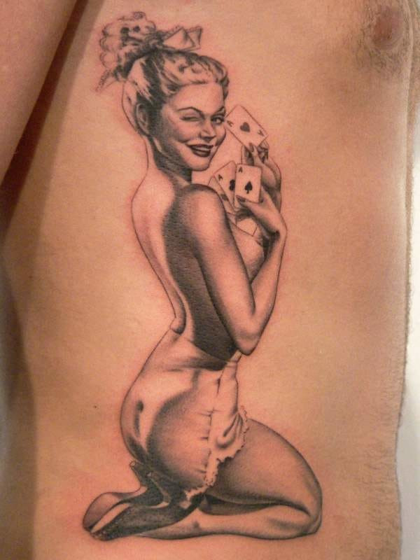Showcase of female pin-up tattoos, highlighting the beauty and artistry of pin-up tattoo designs.