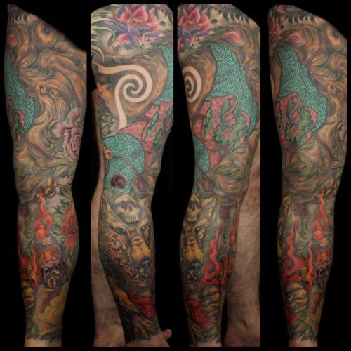 Finished Kitsune leg sleeve tattoo with vibrant colors and geometric patterns, showcasing the completed artwork