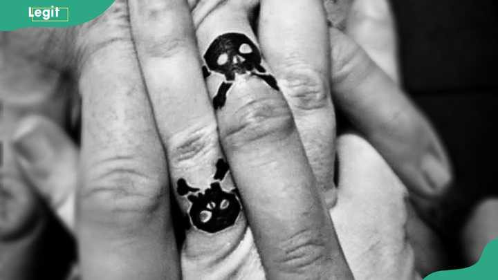 Skull wedding ring tattoo as a bold and edgy symbol of eternal love beyond life.