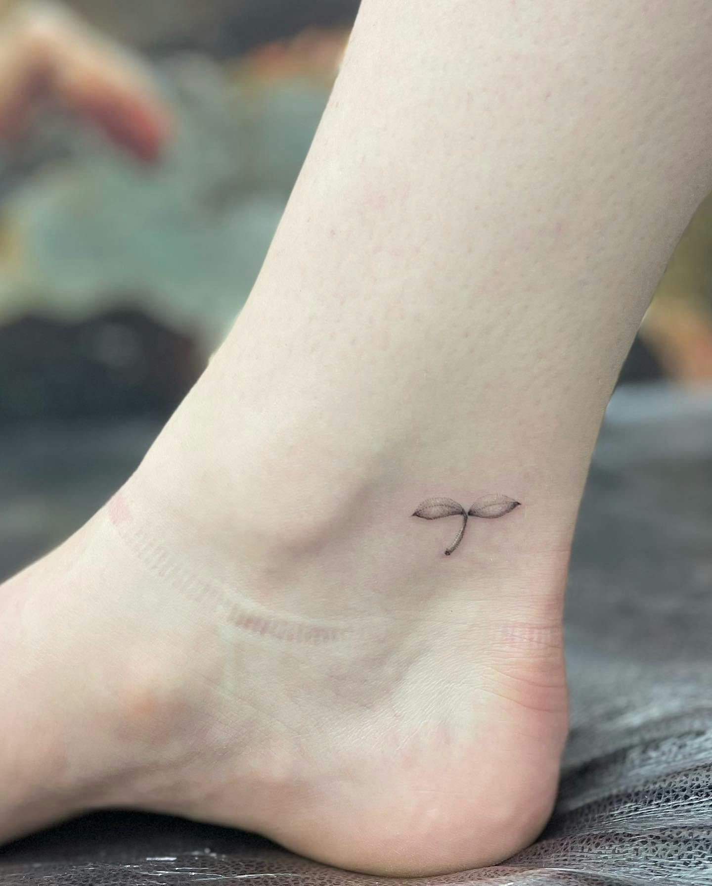 Baby leaf shoot ankle tattoo for growth