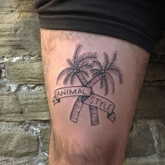 Close-up of Samuel's arm tattoo, a simple black line drawing symbolizing a pivotal moment of warmth and hope experienced in California with friends.