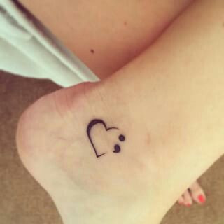 Semicolon tattoo on wrist