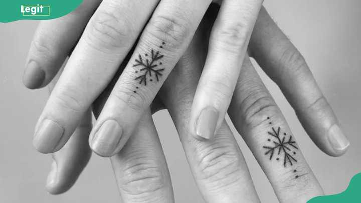 Snowflakes ring tattoo representing purity, renewal, and resilience in love.