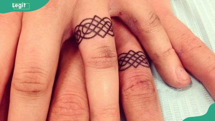 Matching mandala ring tattoo symbolizing unity, balance, and harmony in a relationship.