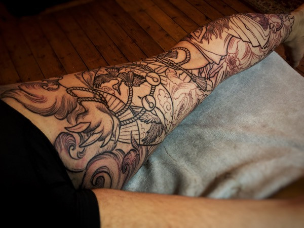 Detailed view of the linework, highlighting the varying line weights and the emerging depth of the tattoo