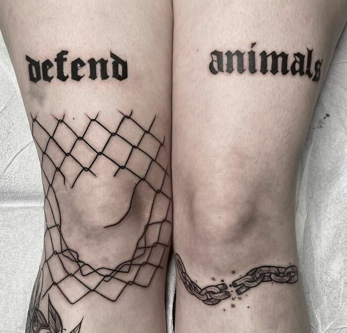 Gothic tattoo featuring stylized lettering on legs, spelling out words in a dark and elegant font.