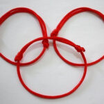 Hand with red string bracelet