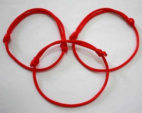 Hand with red string bracelet